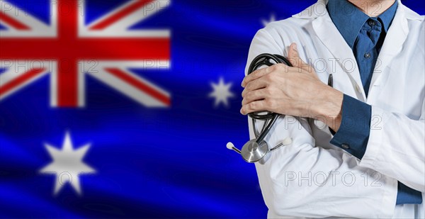 Doctor with stethoscope on Australia flag. Male Doctor holding stethoscope on Australian flag