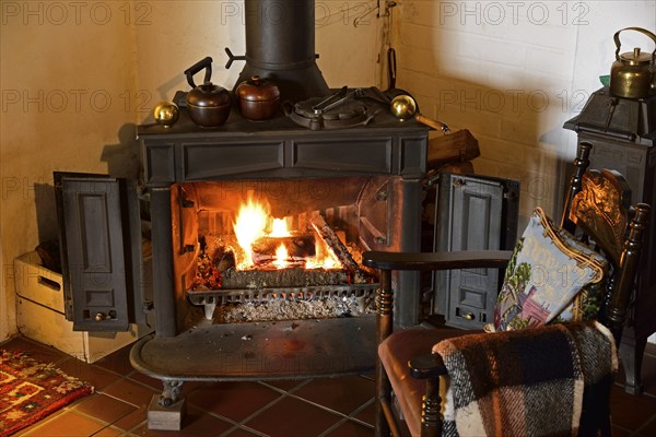 Europe, Germany, fireplace, stove, type Franklin, in living room, chair by the fireplace, Hamburg,
