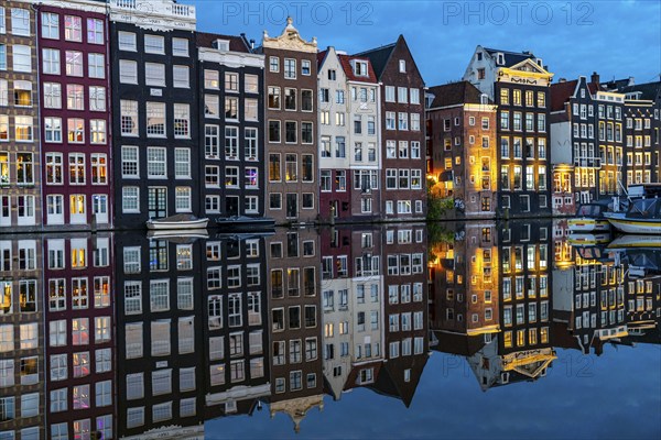 Canal houses on the Damrak, in the centre of the old town of Amsterdam, harbour, starting point of