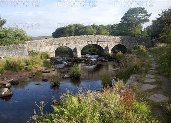 Historic Packhorse bridge at Postbridge, Dartmoor national park, Devon, England crossing the East