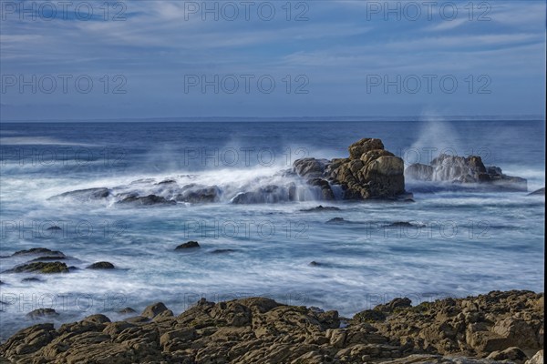 The waves of the Atlantic wash over the rocks on the coast off Penmarch in Brittany. Finistere,