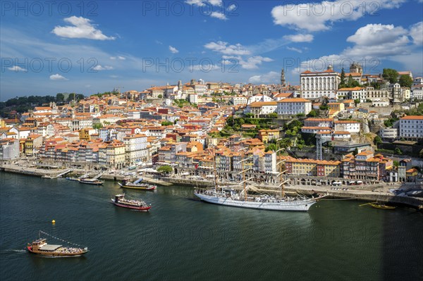 Aerial view of Porto city and Douro river with moored sailling ship from Dom Luis bridge I. Porto,