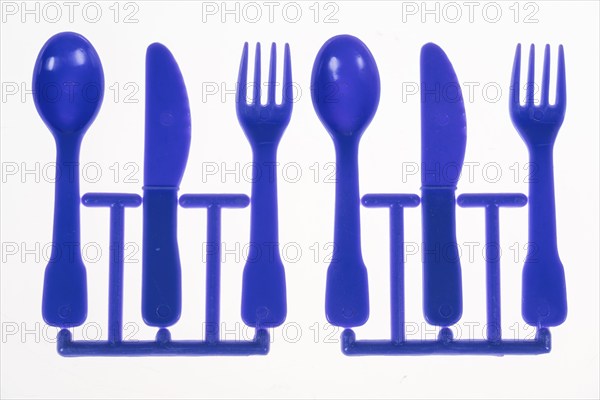 Plastic cutlery, spoon, knife, fork, still on the cast strand, children's cutlery