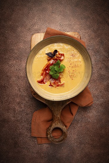 Pumpkin cream soup, curry, fried bacon, top view, no people