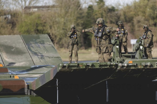 An engineer soldier stands on an amphibious vehicle of the type Amphibie M3 of the Bundeswehr,