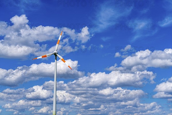 Wind turbine, wind energy plant from the manufacturer Enercon, blue sky with many white clouds,