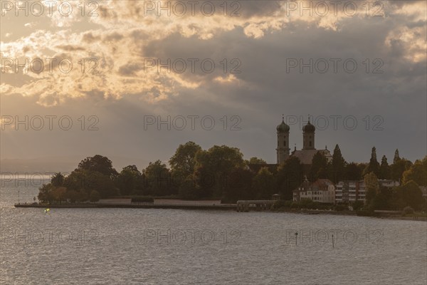 Baroque castle church, double tower, onion dome, evening light, sunbeams, Friedrichshafen on Lake