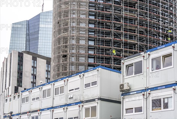 Large construction site, construction of a high-rise residential building, scaffolded shell,