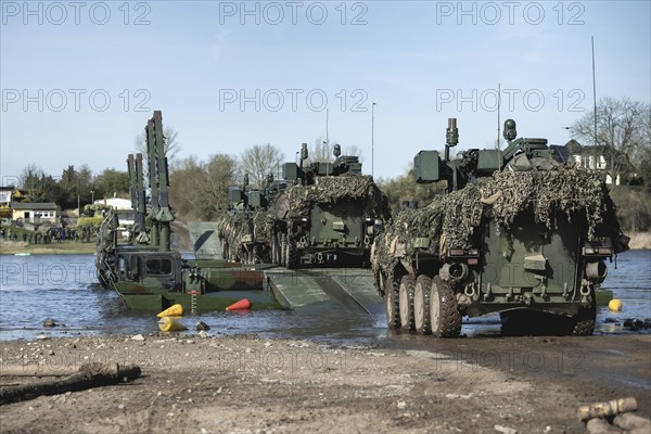 Pandur wheeled tanks of the Czech army drive onto German Bundeswehr vehicles of the Amphibie M3