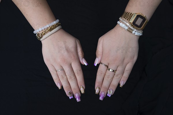 Colourful fingernails of a young woman, on a black background, Baden-Württemberg, Germany, Europe