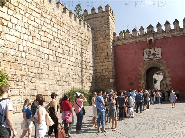 Line of tourists queueing to enter the Alcazar in Seville, Spain, Europe