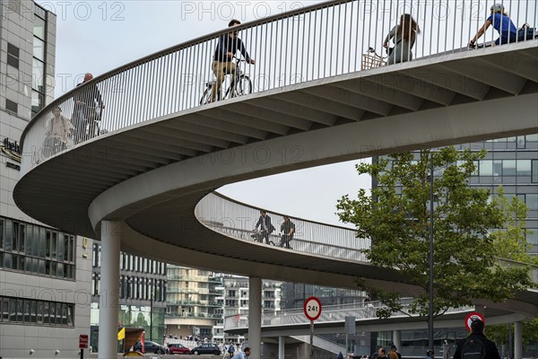 Cyclists on the Cykelslangen cycle and pedestrian bridge, at the Fisketorvet shopping centre,