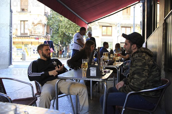 People drinking outside, Cerveceria 100 Montaditos chain bar pub, Madrid city centre, Spain, Europe
