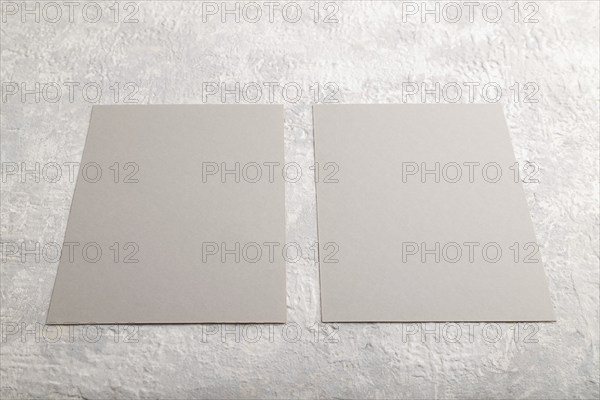 Gray paper business card, mockup on gray concrete background. Blank, flat lay, top view, still