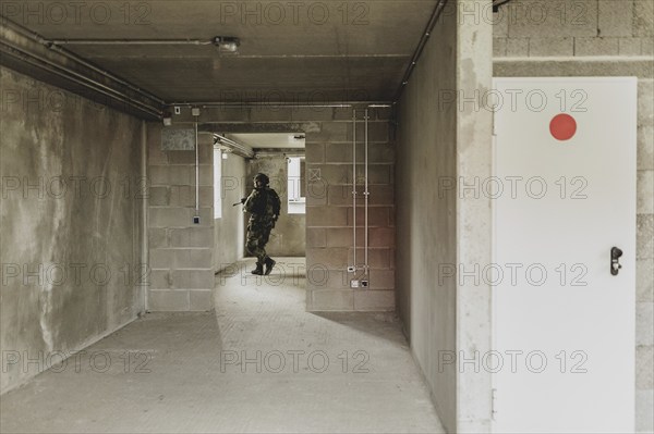 A soldier moves during a simulated house-to-house battle, taken as part of a Bundeswehr exercise