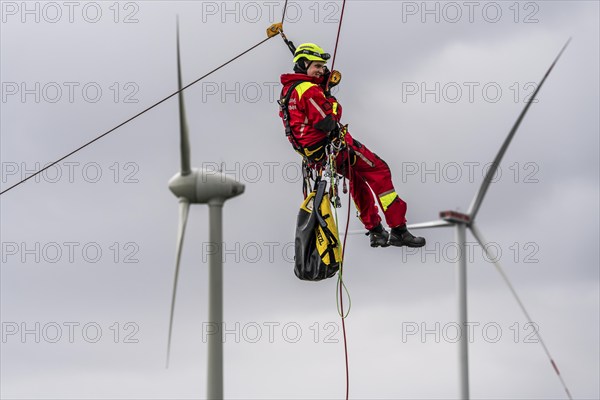 Height rescuers from the Oberhausen fire brigade practise abseiling from a wind turbine from a
