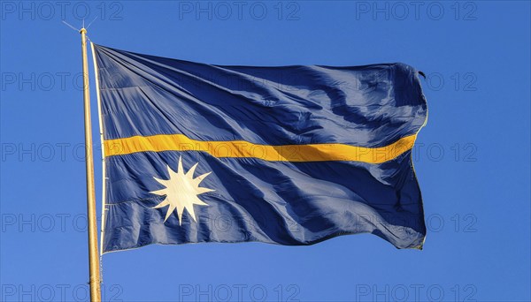 The flag of Nauru, an island nation in the Pacific Ocean, flutters in the wind, isolated against a