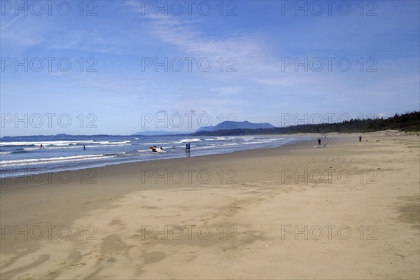 Endless empty sandy beach with swell and mountains in the background, Long Beach, Pacific Rim