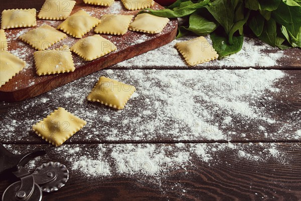 Cheese Ravioli, with spinach and cheese, with ingredients, on a wooden table, horizontal, no