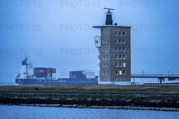 Thick fog in winter, hangs over the mouth of the Elbe into the North Sea, container ship runs into