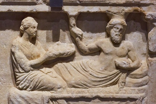 Votive relief, Honouring a hero, Ancient relief of two figures in a reclining scene, carved from