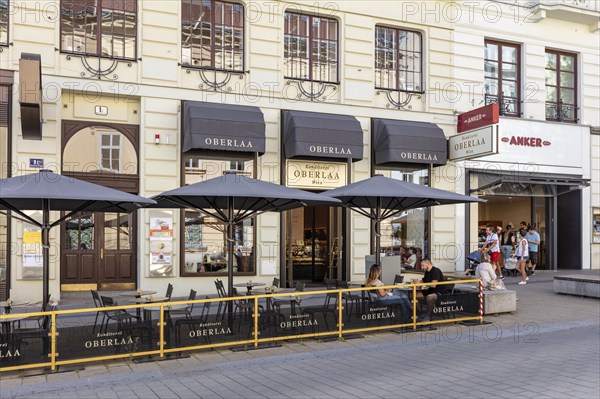 Inviting street café with classic façade and shady parasols, Vienna