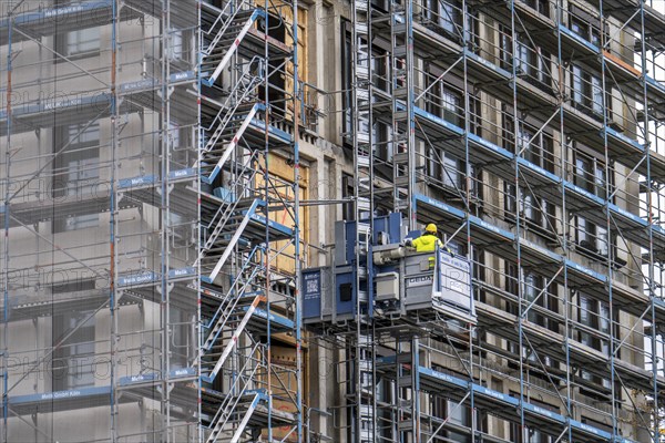 Construction site, construction site lift, new construction of a high-rise office building, facade