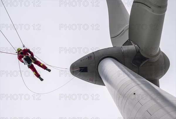 Height rescuers from the Oberhausen fire brigade practise abseiling from a wind turbine from a