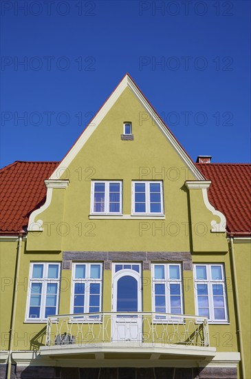 House gable with red tiled roof and white windows against a clear blue sky, Molde, Romsdal, Norway,