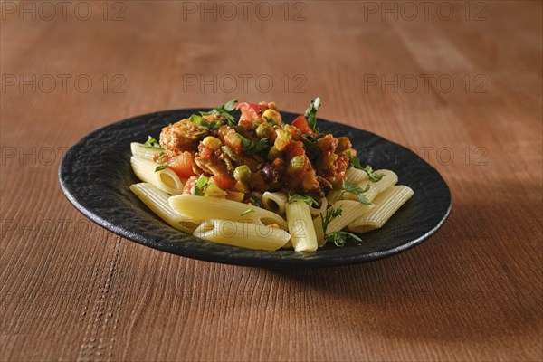 Beef ragout fried with vegetables and spicy sauce with pasta
