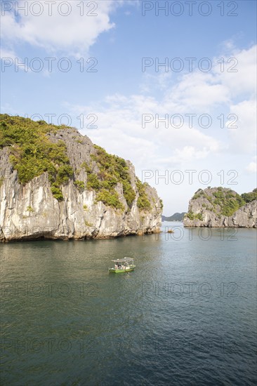 Fishing boat and the karst rocks in Lan Ha Bay, Halong Bay, Vietnam, Asia