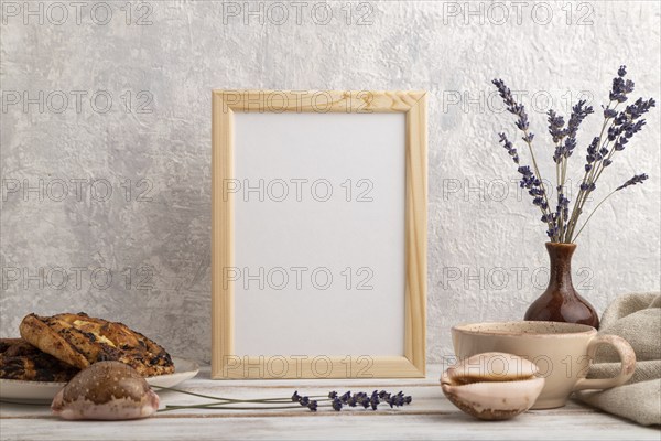 White wooden frame mockup with lavender in ceramic vase, linen textile, cup of coffee and bun on
