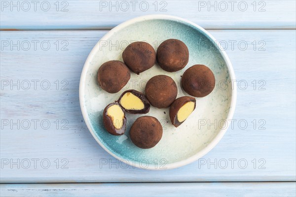 Japanese rice sweet buns chocolate mochi filled with cream on blue wooden background. top view,