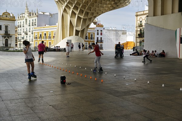 Inline skaters and pedestrians on the Plaza Mayor, Metropol Parasol, Seville, Andalusia, Spain,