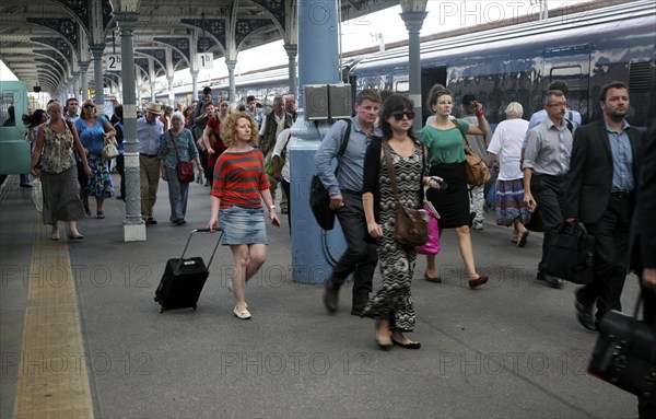 Crowd of passengers leaving their trains on the platform at Norwich railway station, Norfolk,