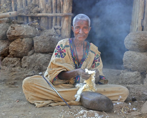 Amhara region, woman sitting on the ground working, plucking cotton, Ethiopia, Africa