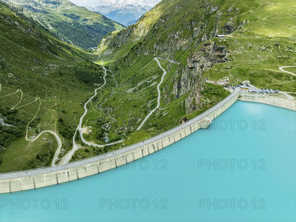 Dam of the Moiry lake, Lac de Moiry, turquoise glacial water, parking lot and restaurant at the