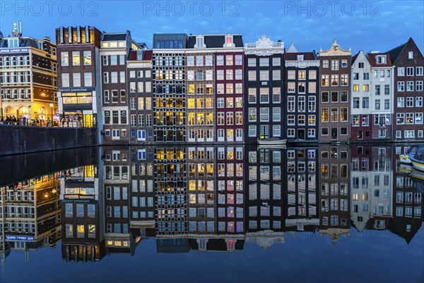 Canal houses on the Damrak, in the centre of the old town of Amsterdam, harbour, starting point of