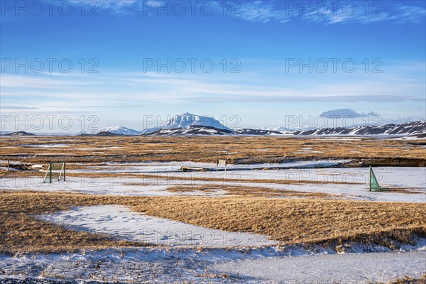 View over snow-covered football playground towards Mt. Herdubreid, winter, farm Mödrudalur, located