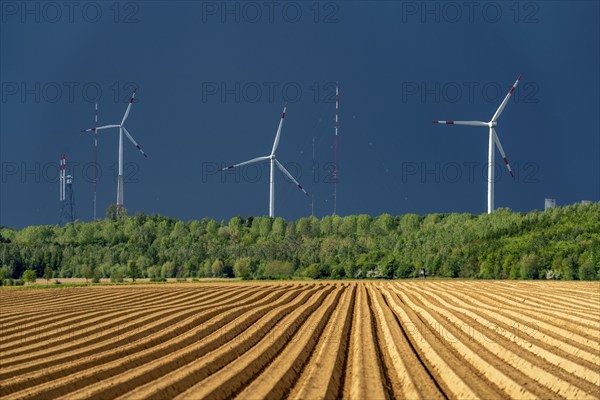 Wind turbines on the Grevenbroich wind test field, dark rain clouds, in the Rhenish lignite mining