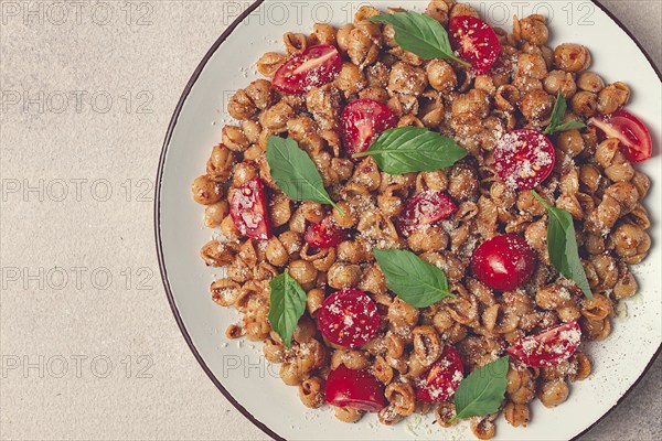 Tuscan pasta with smoked paprika and basil, parmesan cheese, Italian traditional cuisine