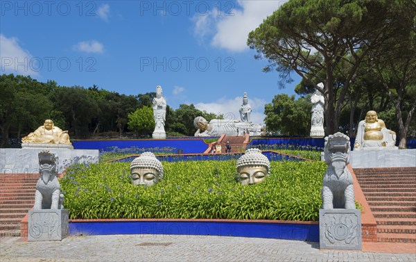 Spiritual garden with several Buddha statues and plants, radiating peace and tranquillity under a
