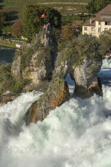 Rhine Falls seen from Laufen Castle, rocky island, Swiss flag, spray, Canton Zurich, on Neuhausen,