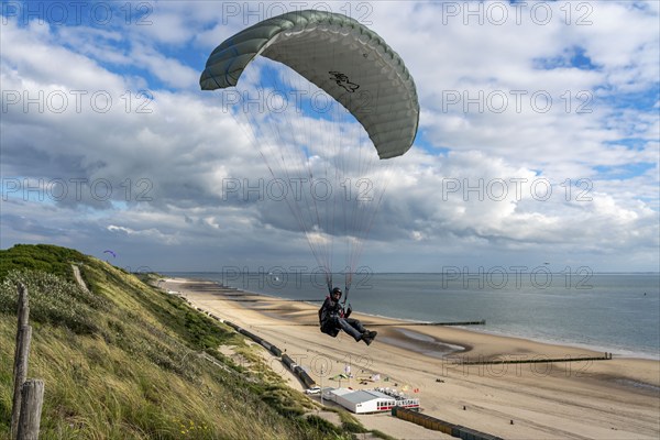 Paragliders along the dunes of Zoutelande, in Zeeland, South Holland, Netherlands