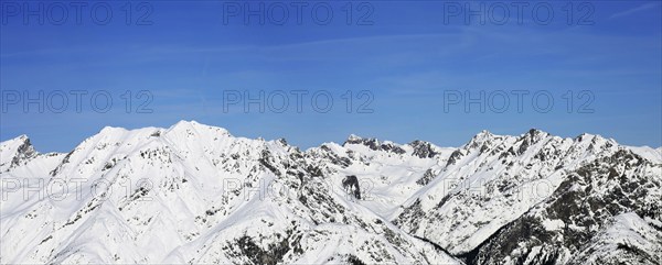 Alpine panorama with snow-covered mountain peaks in winter. Taken in the ski resort of Serfaus Fiss