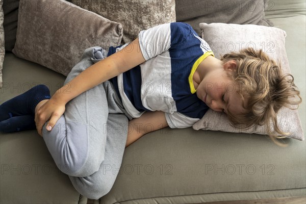 Growing pains in children, boy, 10 years old, has pain in his leg, symbolic picture