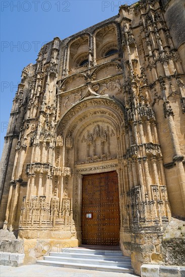 Impressive Gothic church façade with ornately carved portal and massive stone doors, Basilica Santa