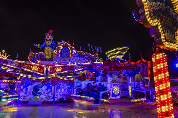 Illuminated round and elevated ride Circus Circus at standstill, night shot, Oktoberfest,