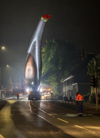 Transport of a 68 metre long, 22 tonne blade of a wind turbine, here in Breckerfeld, with a