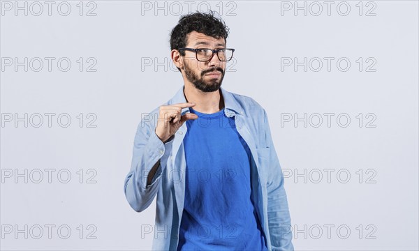 Man showing a small amount with fingers isolated. Young man gesturing with hand showing something